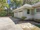 Attached two car garage with white doors, green shutters and siding, for a fresh look at 321 Heather Ct., Sunset Beach, NC 28468