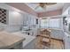 Well-lit kitchen with white cabinetry, tiled countertops, and an island for food preparation at 321 Heather Ct., Sunset Beach, NC 28468