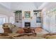 Bright living room with fireplace, built-in shelving, and large windows for natural light at 321 Heather Ct., Sunset Beach, NC 28468