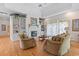 Inviting living room with a fireplace, large windows, and comfortable seating at 321 Heather Ct., Sunset Beach, NC 28468