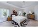 Bright staged main bedroom with modern furnishings, a large bed, and natural light at 321 Heather Ct., Sunset Beach, NC 28468