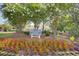 Sign that reads 'Pink Palace Members & Guests Only' with flowering trees and vibrant greenery at 321 Heather Ct., Sunset Beach, NC 28468