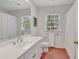 Well-lit bathroom features a large mirror, white vanity, and shower with a white curtain at 356 Chapman Loop, Pawleys Island, SC 29585