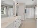 Bright bathroom boasts a double vanity, white cabinets, and shower with a white curtain at 356 Chapman Loop, Pawleys Island, SC 29585