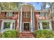 Close-up of the home's entrance with white columns and a brick facade plus a charming doorway at 356 Chapman Loop, Pawleys Island, SC 29585