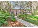 Charming brick home with mature trees and manicured landscaping along a winding walkway at 356 Chapman Loop, Pawleys Island, SC 29585