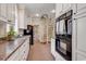Open kitchen features a spiral staircase and modern appliances at 356 Chapman Loop, Pawleys Island, SC 29585
