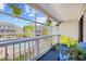 Balcony overlooking pool and landscape, complete with chairs and plants at 3700 Golf Colony Lane # 18-G, Little River, SC 29566