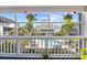 Balcony view of the pool and neighboring buildings, decorated with hanging flowers at 3700 Golf Colony Lane # 18-G, Little River, SC 29566