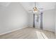 A bright bedroom featuring luxury vinyl flooring, a ceiling fan, and natural light from the window at 3700 Golf Colony Lane # 18-G, Little River, SC 29566