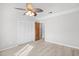 Bright bedroom with light wood floors, ceiling fan, and ample closet space at 3700 Golf Colony Lane # 18-G, Little River, SC 29566