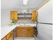 Modern kitchen featuring stainless appliances, mosaic backsplash, under cabinet lighting, and wood cabinets at 3700 Golf Colony Lane # 18-G, Little River, SC 29566