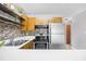 The kitchen is equipped with stainless appliances, tile backsplash, and bright countertops at 3700 Golf Colony Lane # 18-G, Little River, SC 29566