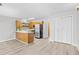 Modern kitchen featuring stainless appliances, open-concept layout, and wood flooring at 3700 Golf Colony Lane # 18-G, Little River, SC 29566