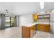 Bright kitchen and living area offering a breakfast bar, ceiling fan, and access to the balcony at 3700 Golf Colony Lane # 18-G, Little River, SC 29566