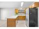 The kitchen features stainless appliances, white countertops and a breakfast bar with seating for two at 3700 Golf Colony Lane # 18-G, Little River, SC 29566