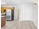 An open-concept living area showing kitchen, stainless appliances, and bi-fold closet at 3700 Golf Colony Lane # 18-G, Little River, SC 29566