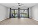 Spacious living room with sliding glass doors and a view of the community at 3700 Golf Colony Lane # 18-G, Little River, SC 29566