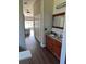 Hallway view of a bathroom with double vanity, granite countertops, and spacious wardrobe at 388 Carriage Lake Dr., Little River, SC 29566