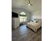 Well-lit bedroom with vaulted ceiling, fan, neutral decor, and large window at 388 Carriage Lake Dr., Little River, SC 29566