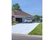 Spacious driveway leading to a two-car garage, with a view of the pond at 388 Carriage Lake Dr., Little River, SC 29566