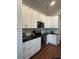 Bright kitchen features white cabinets, black countertops, and stainless steel appliances at 388 Carriage Lake Dr., Little River, SC 29566