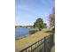 A serene lake view from behind a black metal fence at 388 Carriage Lake Dr., Little River, SC 29566