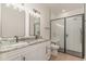 Modern bathroom featuring double vanity with granite countertop, framed mirrors, and glass enclosed shower at 4010 Macks Rd, Aynor, SC 29511