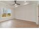 Bright, open bedroom features a decorative tray ceiling, a ceiling fan, and a large window at 4010 Macks Rd, Aynor, SC 29511