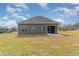 Exterior of the home featuring green siding, gray roof, and backyard with patio at 4010 Macks Rd, Aynor, SC 29511