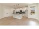 Modern white kitchen with an island, black backsplash, and stainless steel appliances at 4010 Macks Rd, Aynor, SC 29511
