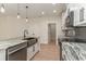 This modern kitchen features a stainless farmhouse sink, stainless appliances, and granite countertops at 4010 Macks Rd, Aynor, SC 29511