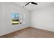 Sunlit bedroom with light wood flooring and a large window and ceiling fan at 4016 Macks Rd, Aynor, SC 29511