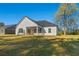 Rear exterior view showcasing the patio and expansive backyard at 4016 Macks Rd, Aynor, SC 29511