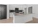 Island kitchen showcases granite countertops and modern appliances against a white cabinet backdrop at 4016 Macks Rd, Aynor, SC 29511