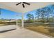 Covered patio overlooking a spacious backyard and scenic tree line at 4016 Macks Rd, Aynor, SC 29511