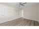 Bedroom with ceiling fan, closet and doorway features wood-look flooring and neutral paint at 4022 Macks Rd, Aynor, SC 29511