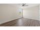 Bedroom with ceiling fan and one window features wood-look flooring and neutral paint at 4022 Macks Rd, Aynor, SC 29511