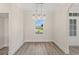 Bright dining room featuring a modern chandelier and large window, plus neutral paint at 4022 Macks Rd, Aynor, SC 29511