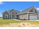 Craftsman-style house showcasing manicured landscaping, a welcoming front porch, and an attached two-car garage at 4022 Macks Rd, Aynor, SC 29511