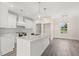Well-equipped kitchen features an island, modern appliances, white cabinetry, and hardwood floors at 4022 Macks Rd, Aynor, SC 29511