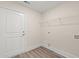 Well-lit laundry room featuring a white door, wire rack shelving and utility connections at 4022 Macks Rd, Aynor, SC 29511