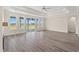 Open concept living room features hardwood floors, tray ceiling, and glass doors to the backyard at 4022 Macks Rd, Aynor, SC 29511
