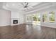 Bright living room features fireplace, ceiling fan, and glass patio doors with outside views at 4022 Macks Rd, Aynor, SC 29511