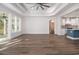 Open-concept living space with wood-look flooring and an archway leading to the kitchen at 4022 Macks Rd, Aynor, SC 29511