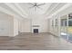 Spacious living room featuring tray ceiling, fireplace, hardwood floors, and glass doors to the backyard at 4022 Macks Rd, Aynor, SC 29511