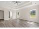 Bright main bedroom with tray ceiling, hardwood floors, and large windows at 4022 Macks Rd, Aynor, SC 29511