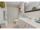 Bathroom with shower/tub combo, decorative mirror, and white sink vanity at 403 Brandymill Blvd, Myrtle Beach, SC 29588