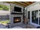 Outdoor patio features brick fireplace with mounted TV, seating, and string lights at 403 Brandymill Blvd, Myrtle Beach, SC 29588