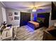 Stylish bedroom featuring laminate wood floors, accent lighting, and modern decor at 408 South Farr Ave., Andrews, SC 29510